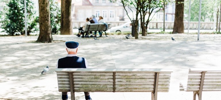 Grandpa sitting alone on the bench.