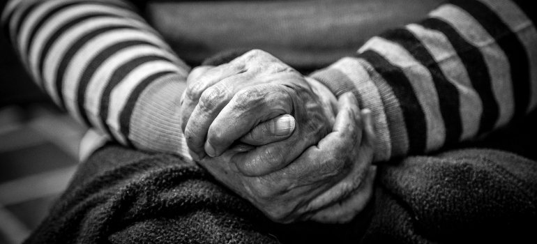 Grandma experiencing Substance Abuse in Elderly Population. Grandma holding two hands together.
