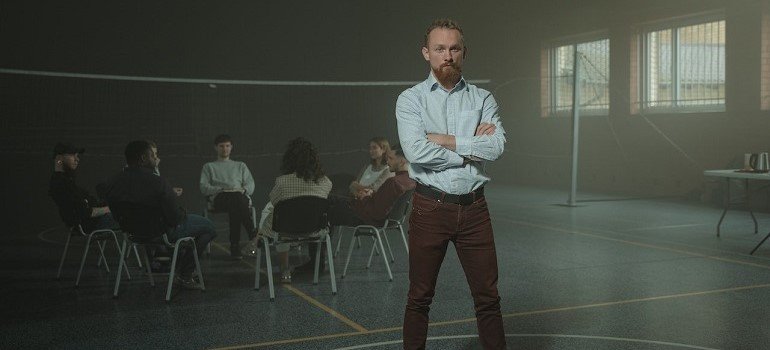 Man standing in front of rehab support group.