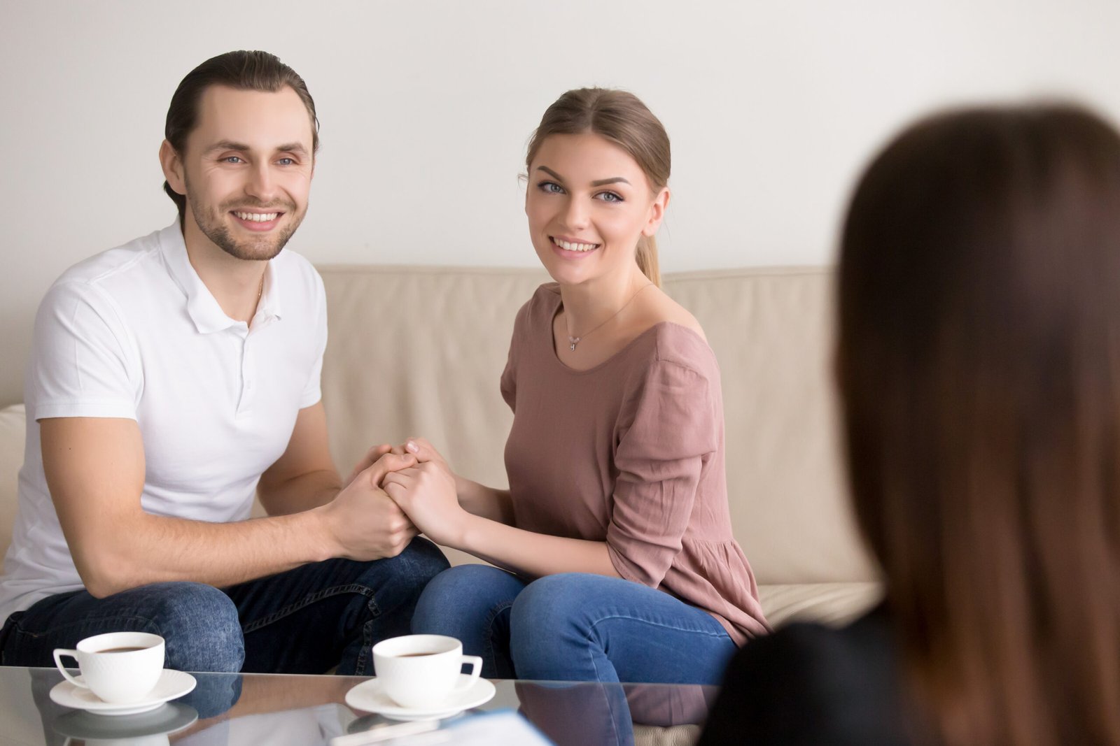 cheerful couple in a consultation, representing Educating the Spouse for Successful Recovery