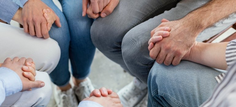 A group of people holding hands together