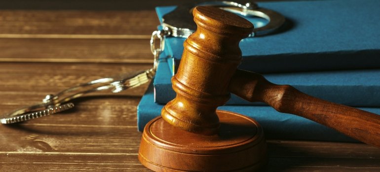 Gavel with books on old wooden desk