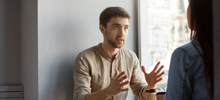 A man expressing his struggles in addiction recovery to a supportive woman