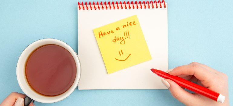 A person writing a positive affirmation note for the day, representing ways to Start Your Day Sober in Pennsylvania