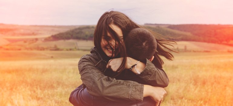 A couple embracing, signifying the support and understanding necessary in dealing with red flags in addiction recovery.