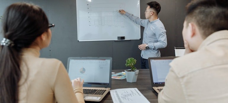 a man writing something on a whiteboard