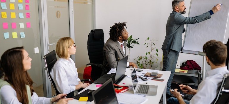 a man presenting Addiction in the Pennsylvania Workforce to a group of his associates in an office