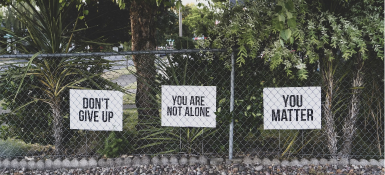 Encouraging signs on a wire fence.