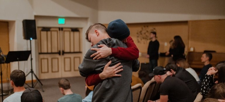 Two people hugging during a support group