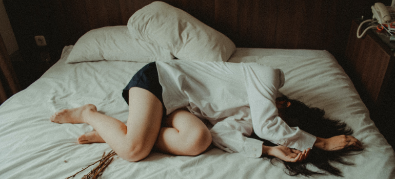 A woman passed out on the bed.