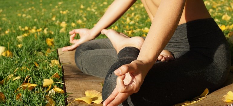 Woman practicing yoga surrounded by fall foliage in Pennsylvania.