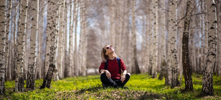 Woman sitting in the woods as one of the ways to cope when you feel anxious without substance abuse in PA