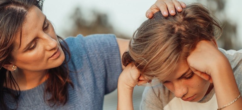 A mother comforting her teenage son and talking about the early-onset alcoholism in Pennsylvania's population.