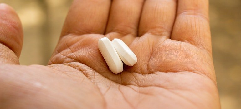 Two Xanax pills on a person's palm