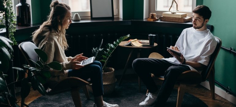 Couple sitting in their living room and working on their laptops