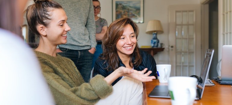 two women reading on a laptop about the impact of addiction on the prison population in PA