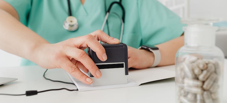 A doctor stamping papers