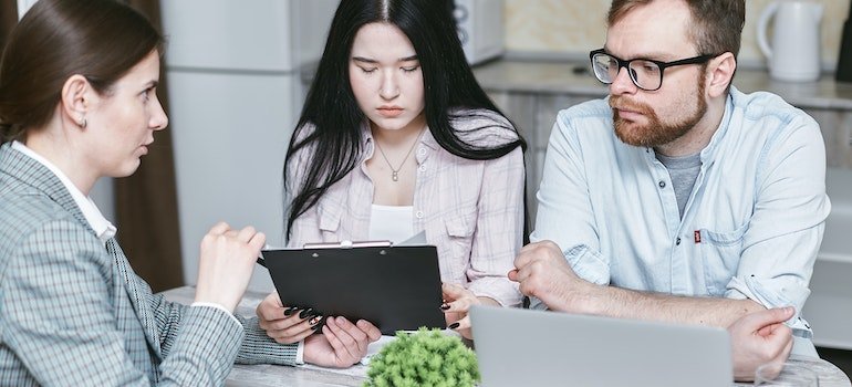 Insurance expert explaining insurance coverage to two people