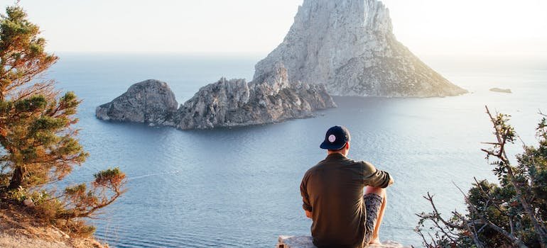 man sitting on a shore