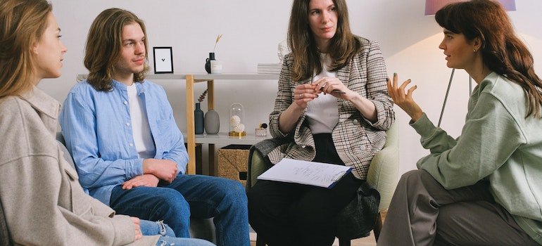 woman sharing her problem during group therapy