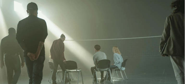 A group of people starting a group therapy session in an indoor tennis field, illustrating the impact of sports and physical activity in Pennsylvania.