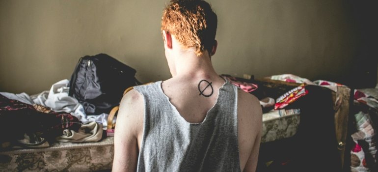 Picture of a person in a messy room 