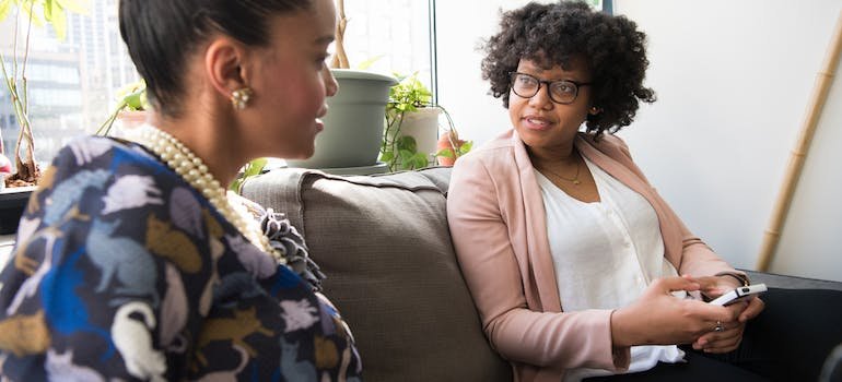 two woman siting and talking