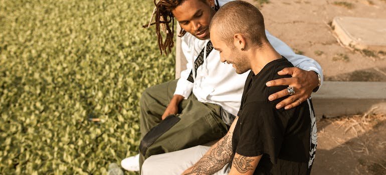 A man consoling his friend outside
