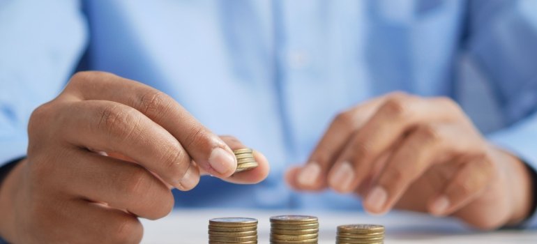 Picture of a person who is stacking coins to help their loved one who refuses to acknowledge their addiction