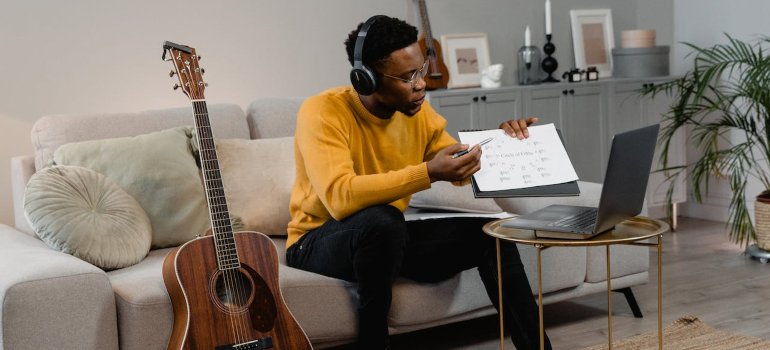 a person with a guitar and a piece of paper