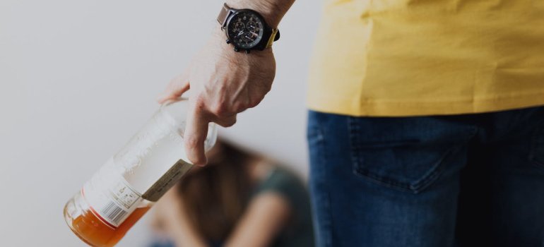 a person holding a bottle