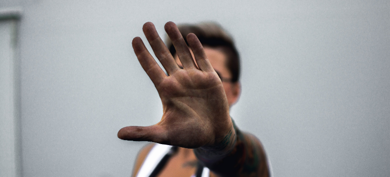 a man saying stop to risks and dangers of quitting alcohol cold turkey 