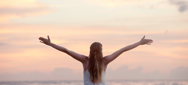 a woman putting her hands in the air