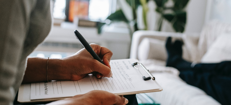 a professional taking notes on the topic risks and dangers of quitting alcohol cold turkey 