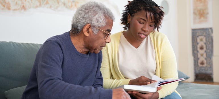 A Woman Reading a Book while Sitting Beside the Man in Blue Sweater representing comparing Gabapentin vs Xanax 