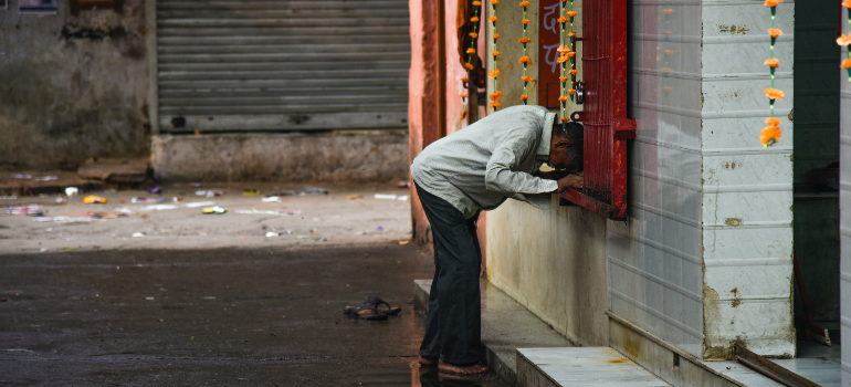 a man leaning against a sill not feeling good