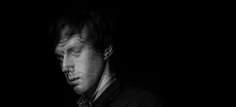 a blurry man in black on a a black background