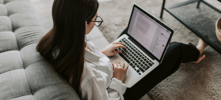 a girl reading on her laptop