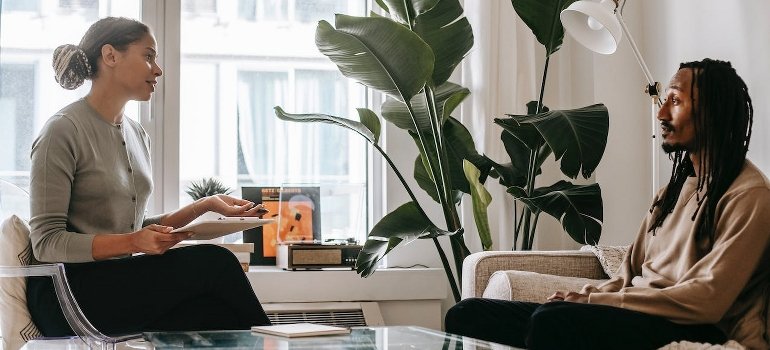 A man is speaking with a psychologist about family-centered recovery at Little Creek.