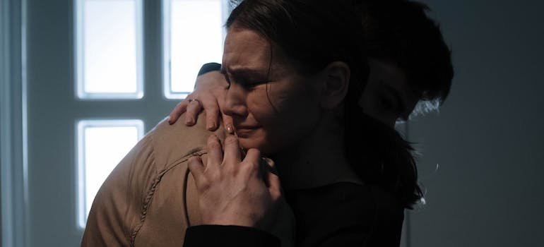 couple hugging and crying.
