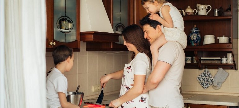 A happy family of four in the kitchen.