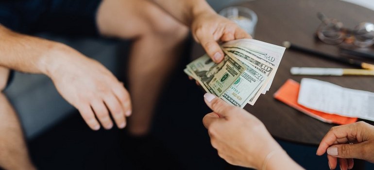 One of the family members of addicts giving money to another person.