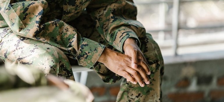 A veteran in uniform siting.