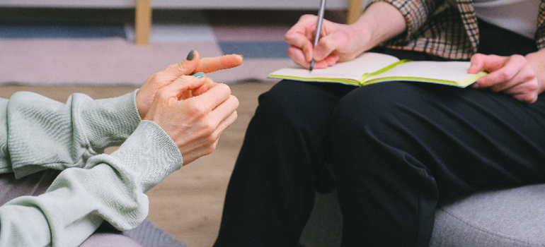 a one-on-one session in progress with a therapist taking notes