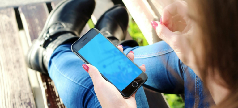 a girl holding a phone and discovering the role of digital health technologies in addiction recovery in Pennsylvania