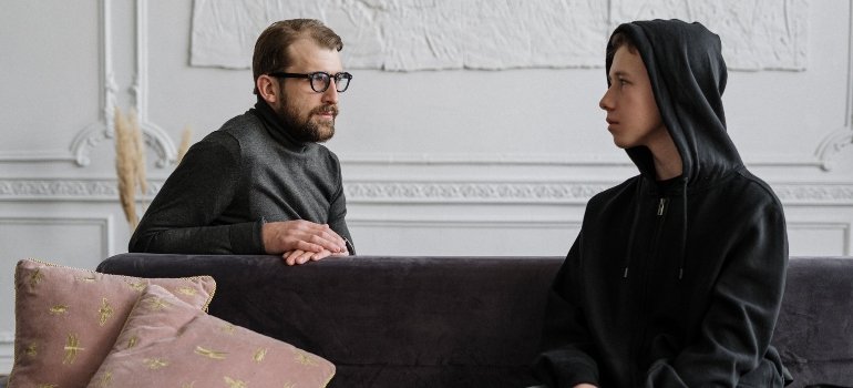 A person talking to a terapist about how social media influences substance abuse among PA adolescents.