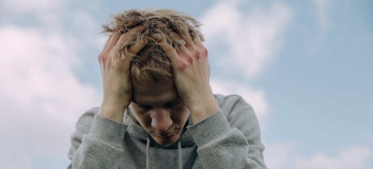 A man holding his head in pain.