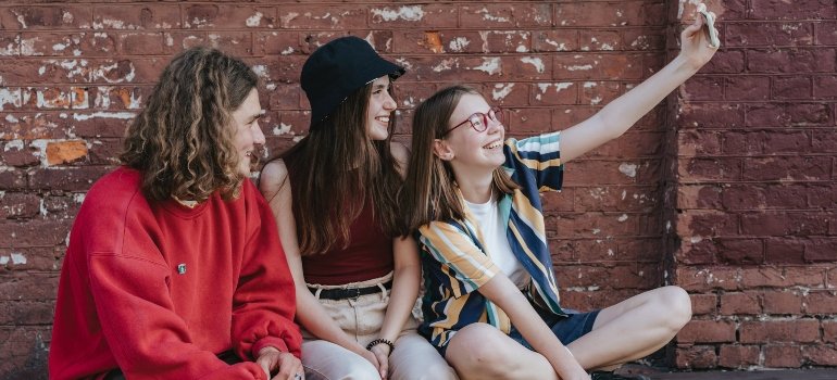 Teens taking a photo with a phone.