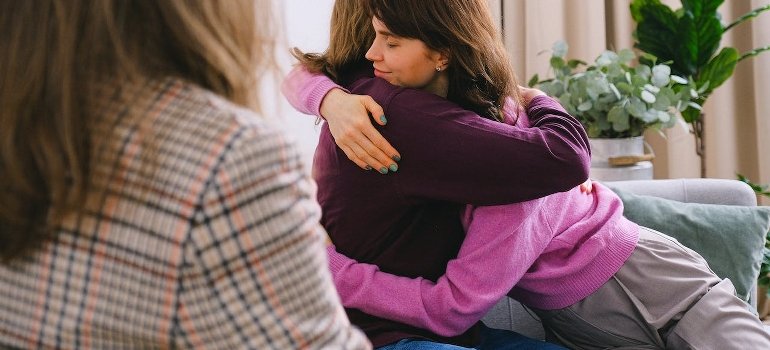 Two persons are hugging at a therapy session at rehab Allentown PA.