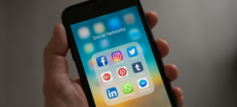 A person holding a phone to search how social media influences substance abuse among PA adolescents.